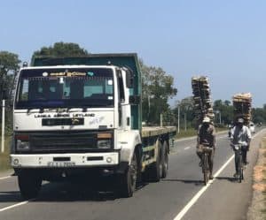 cyclists with huge tall wood